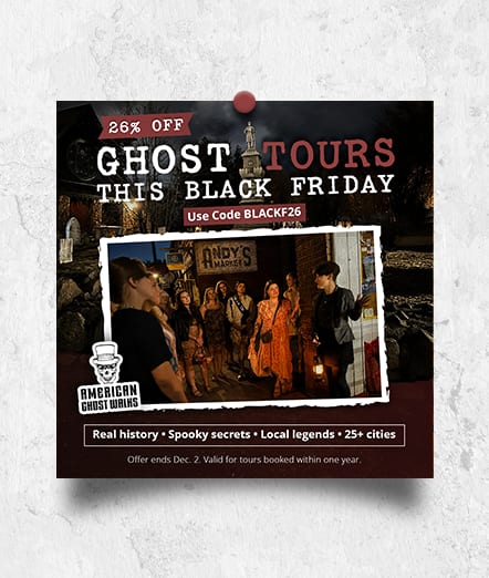 American Ghost Walks ad “Ghost Tours This Black Friday”: 26% off with code BLACKF26, a guide leading a tour group by lantern light