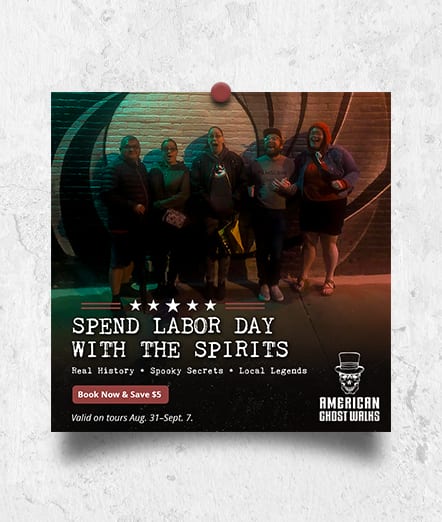 American Ghost Walks ad “Spend Labor Day With the Spirits”: a tour group posing in front of a brick wall at night